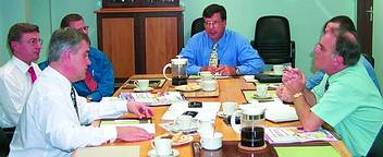 Graham Robertson and Colin Moger of International Rectifier,(left)discuss details of the company with Maurice McDowell of Technews(right)